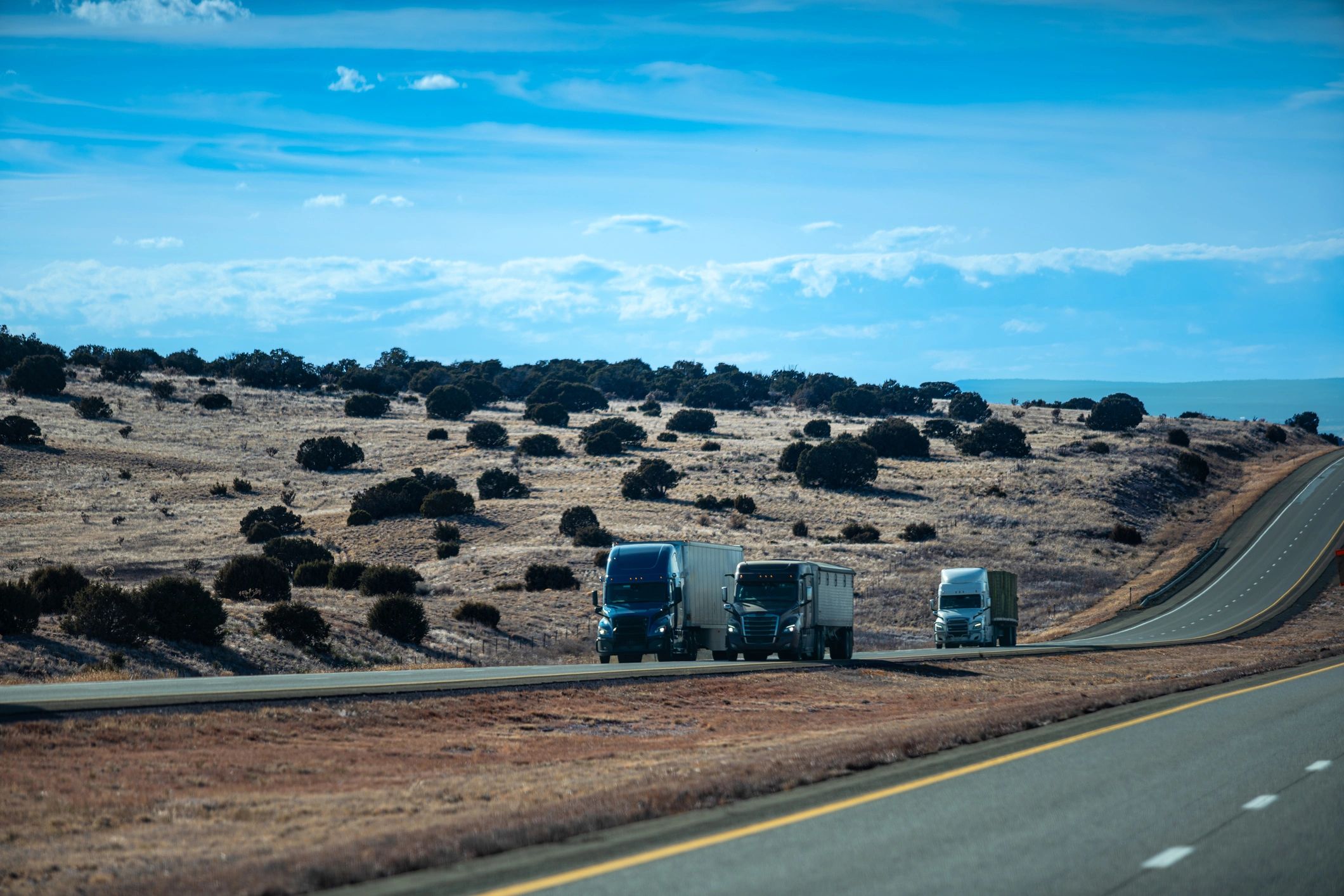 Commercial fleet trucks traveling together
